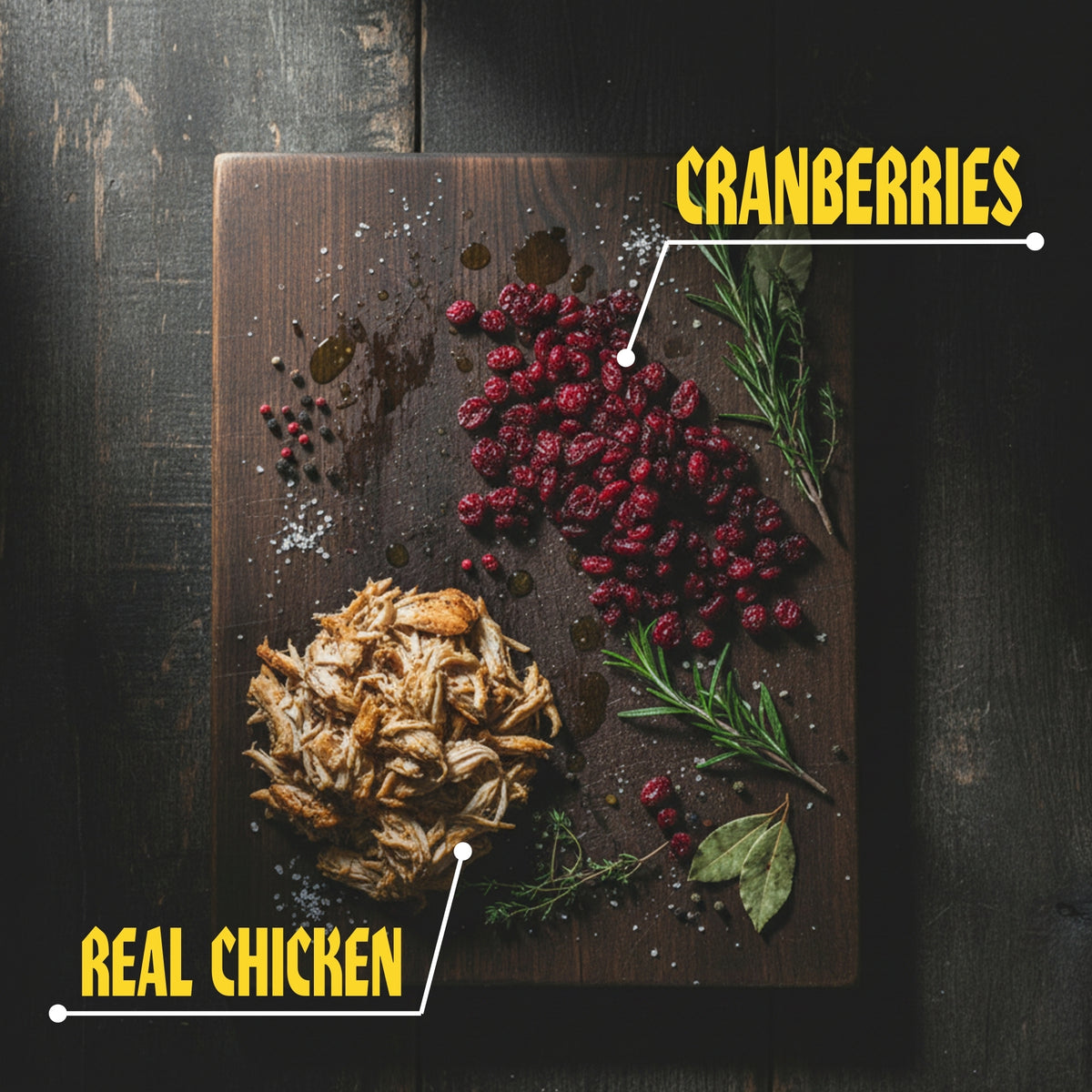 Wooden cutting board with cranberries and shredded chicken on a dark surface